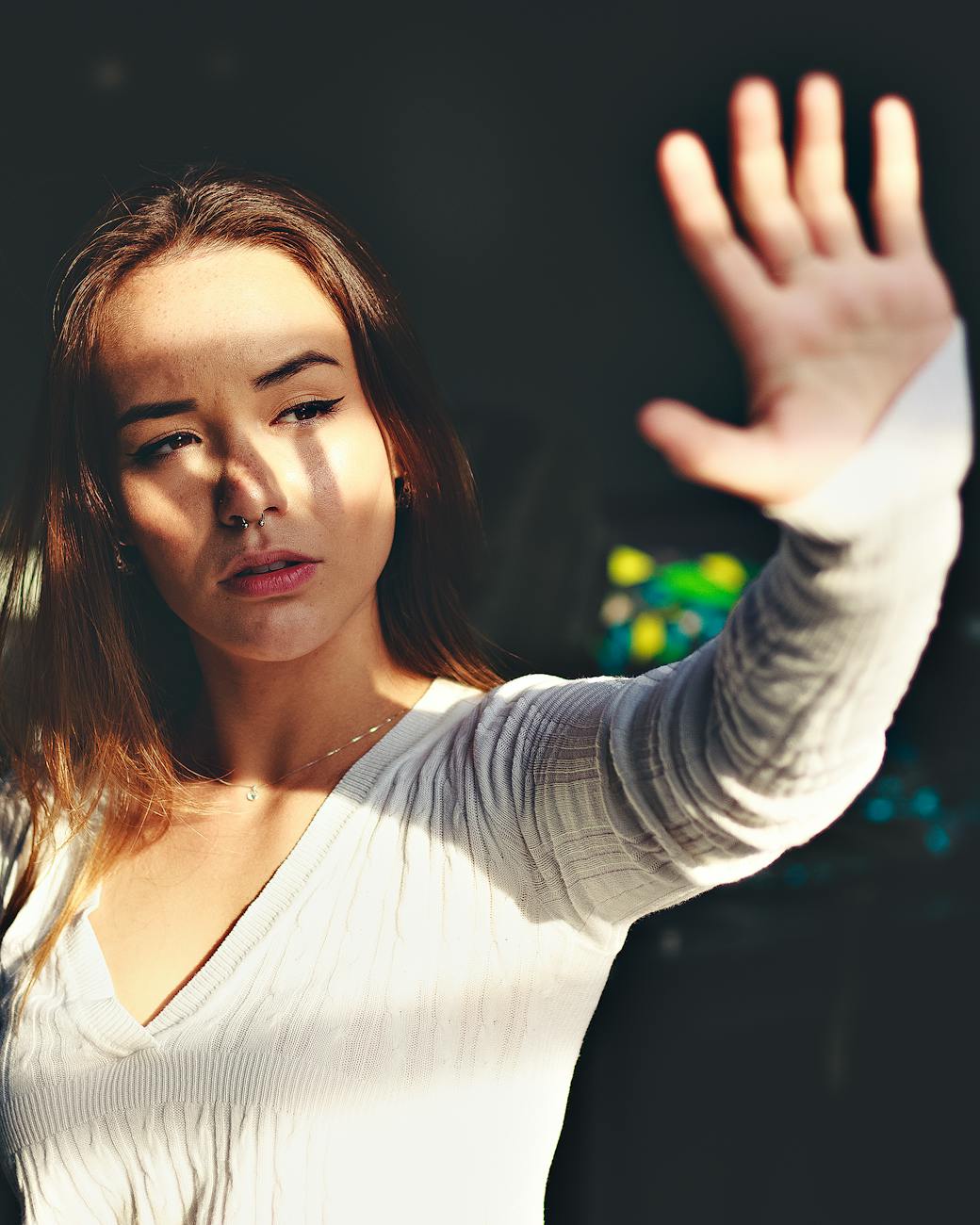 woman covering face by sunlight
