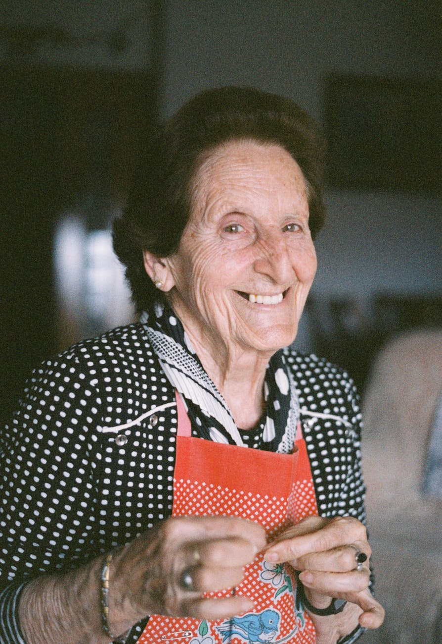 elderly woman wearing apron