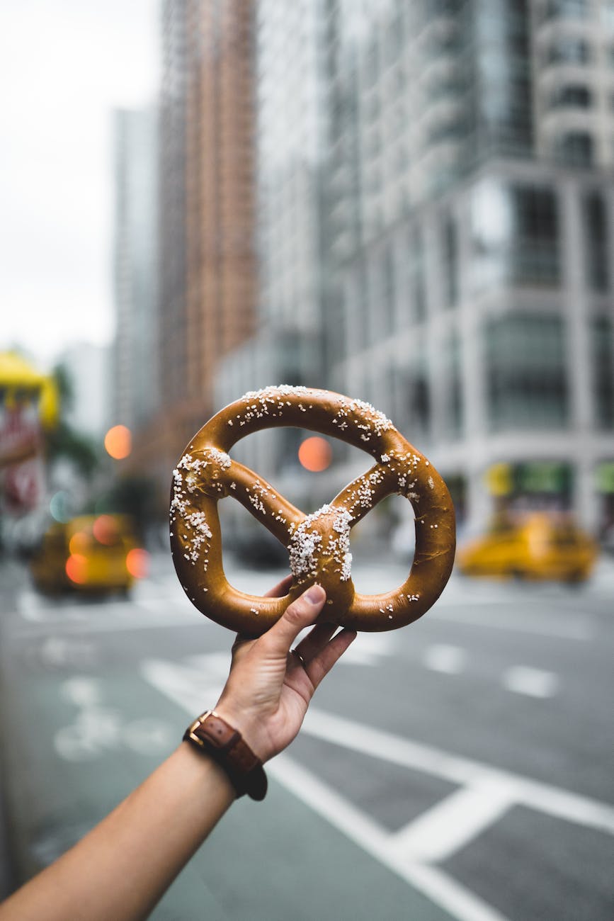 photo of person holding pretzels