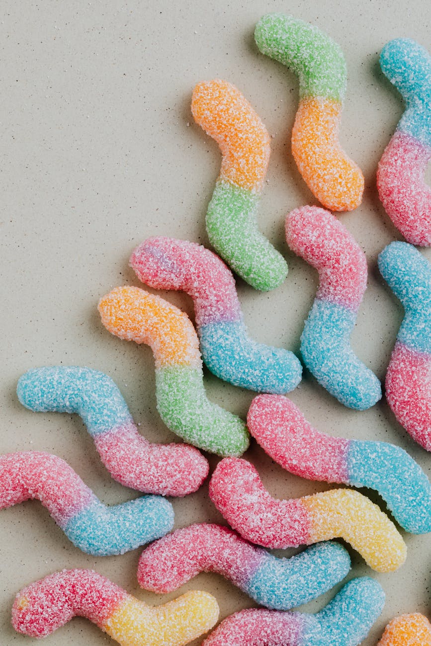 colorful marmalade with sugar on gray background