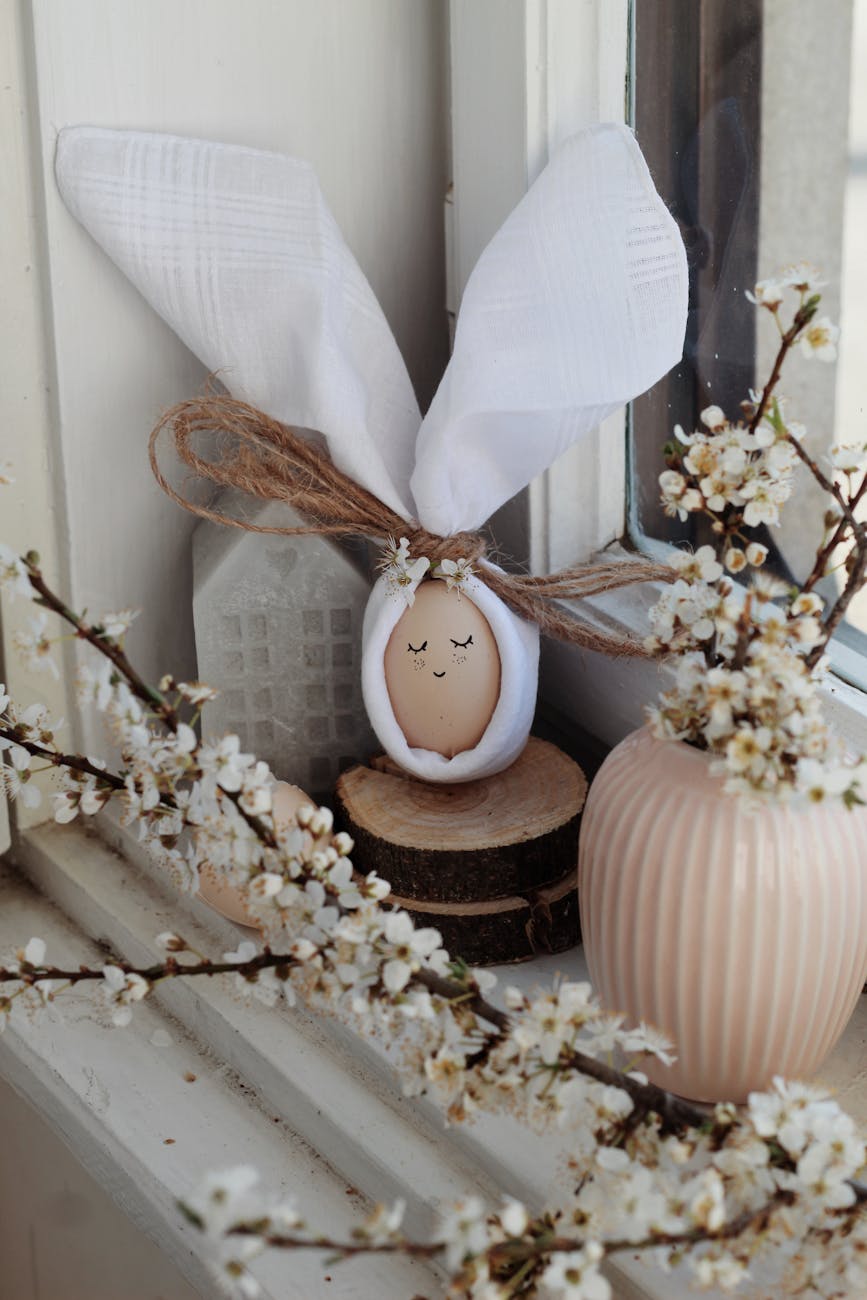 egg and flowers on windowsill at home