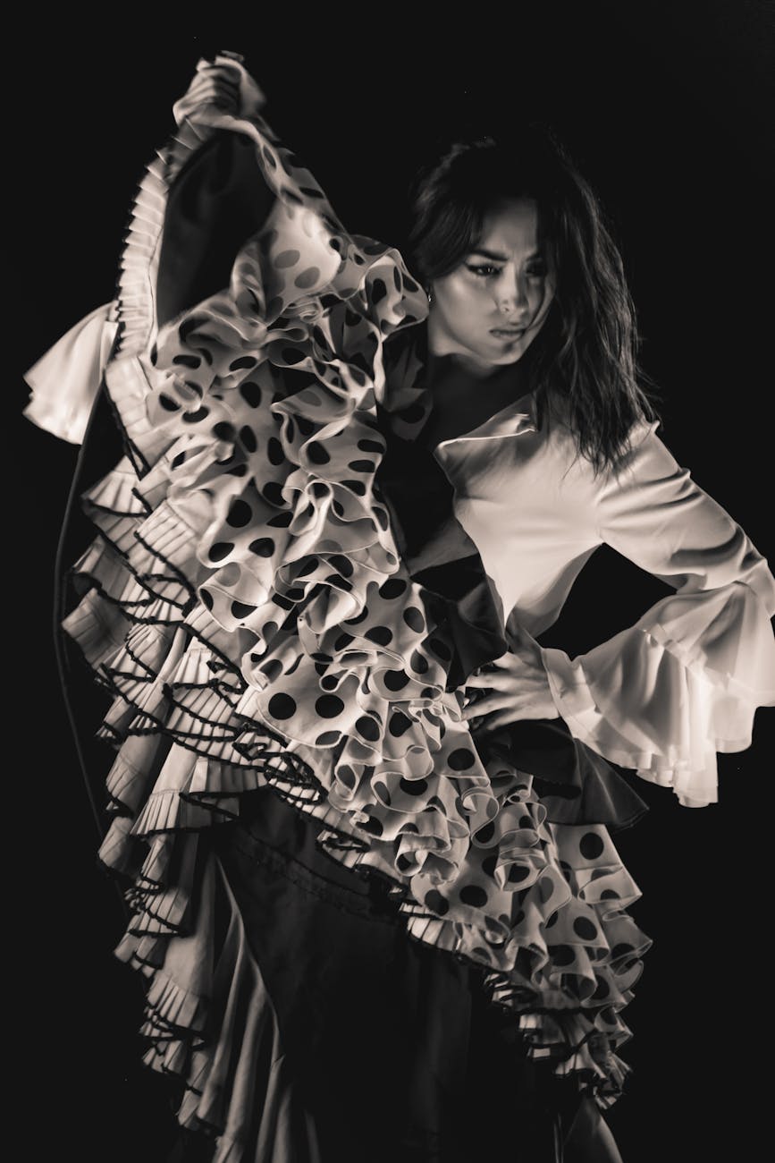 a woman in a polka dot long sleeves dress dancing