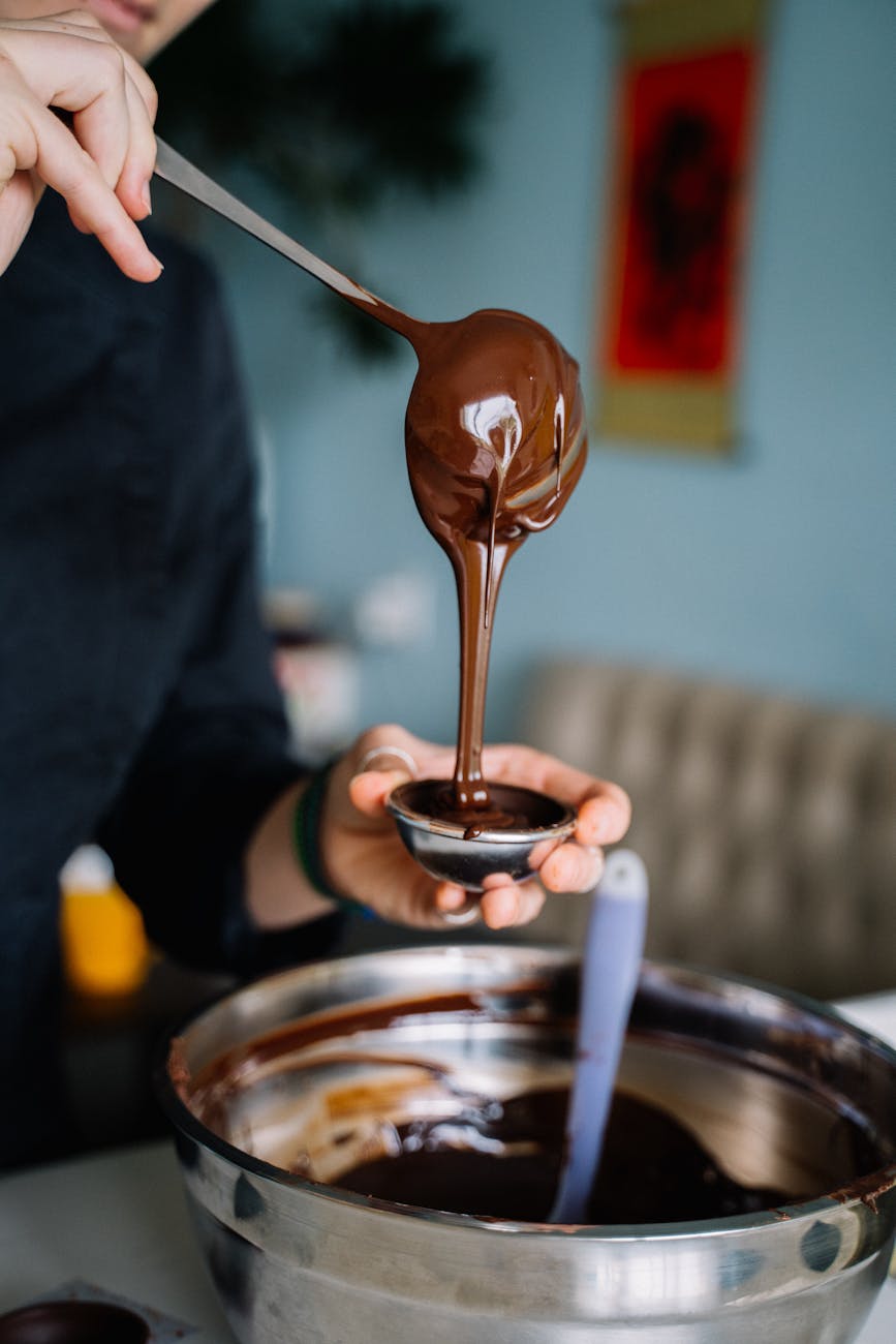 photo of person pouring chocolate on a silver mini bowl