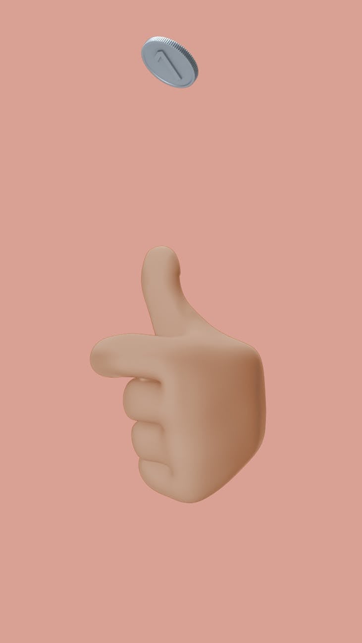 a hand tossing a coin