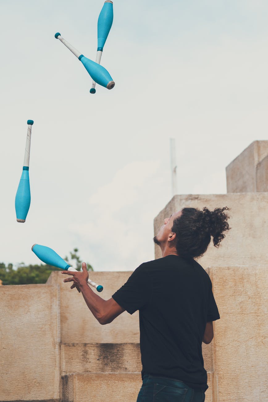 a man juggling pins in the air
